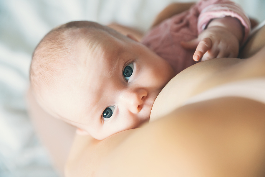 newborn resting on shoulder of the mother